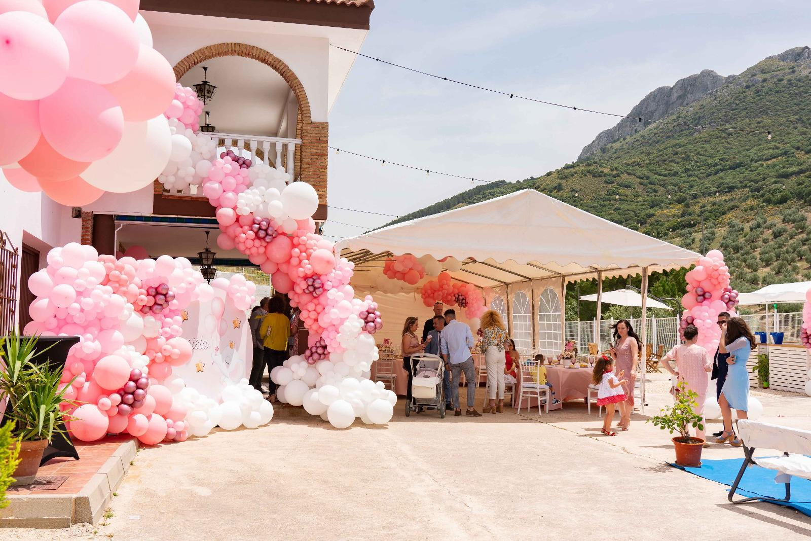 Celebración al aire libre en Villa de Dulce con carpa y globos